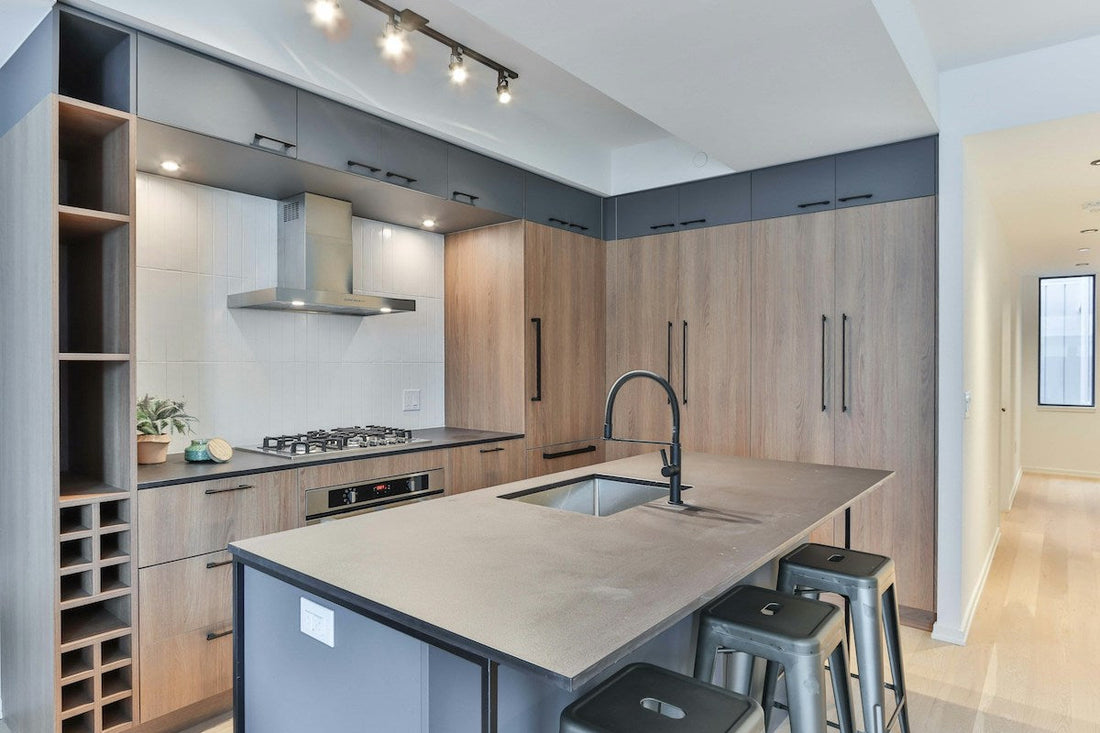 A sleek, matte black faucet in a beautiful kitchen with an island.